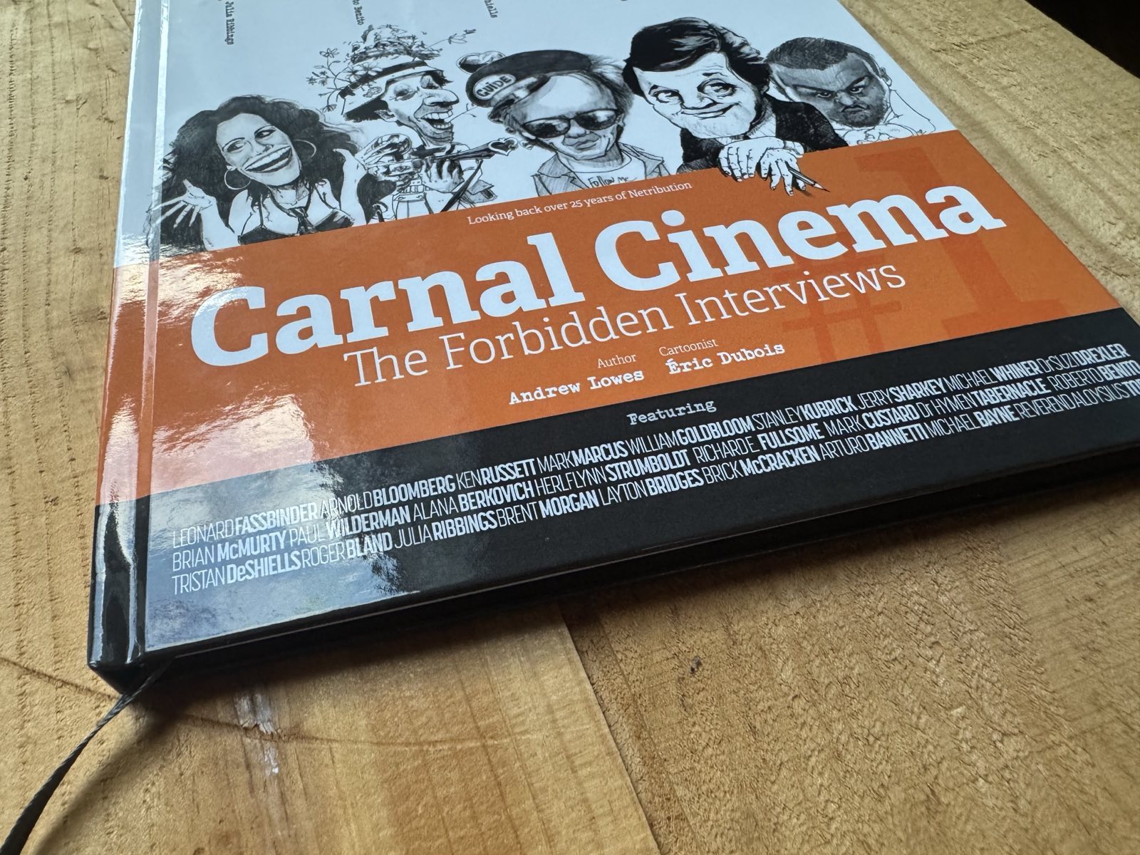 Photograph of Carnal Cinema hardback book on wooden background.